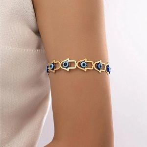 Gold evil eye hamsa arm cuff